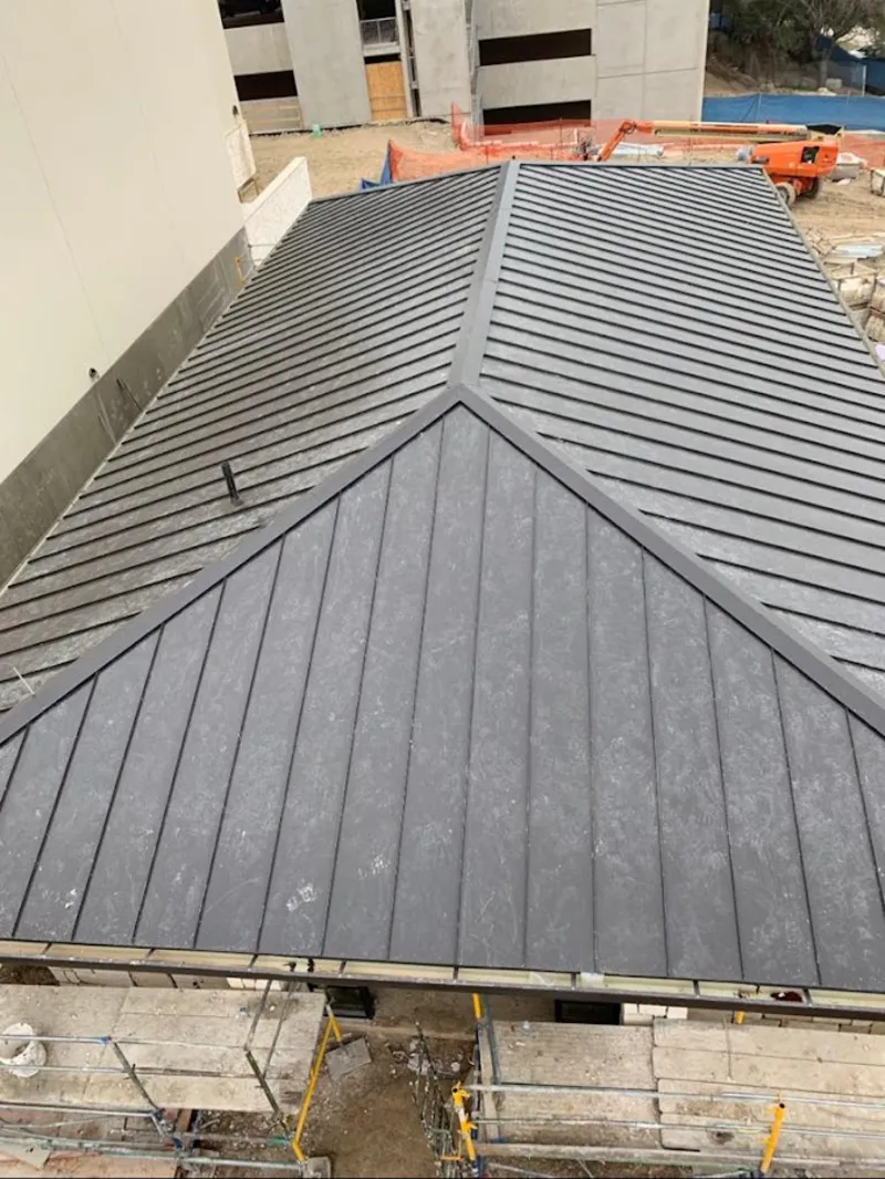 Commercial metal roof construction with crane equipment in North Union