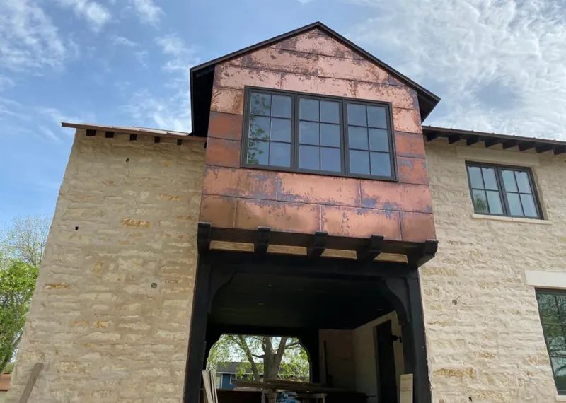 Copper metal panel facade on a stone building for Roof Repair in North Union